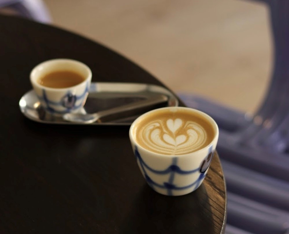 flat white in trendy .coffee cup with ceramic glazed pattern 