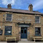 The exterior of The Old Grindstone on a sunny day.