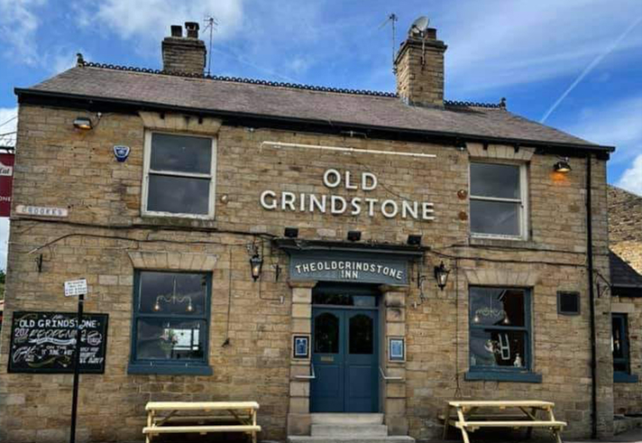 The exterior of The Old Grindstone on a sunny day.