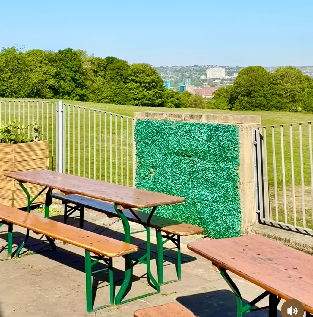 outdoor seating area at Dukes in the Park with the city in the distance 