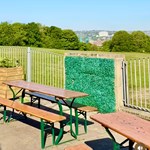 outdoor seating area at Dukes in the Park with the city in the distance