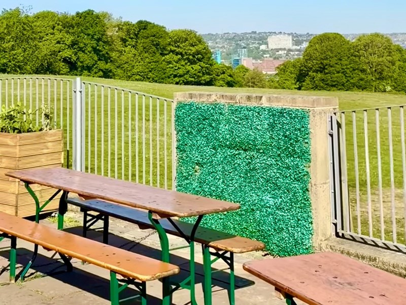 outdoor seating area at Dukes in the Park with the city in the distance