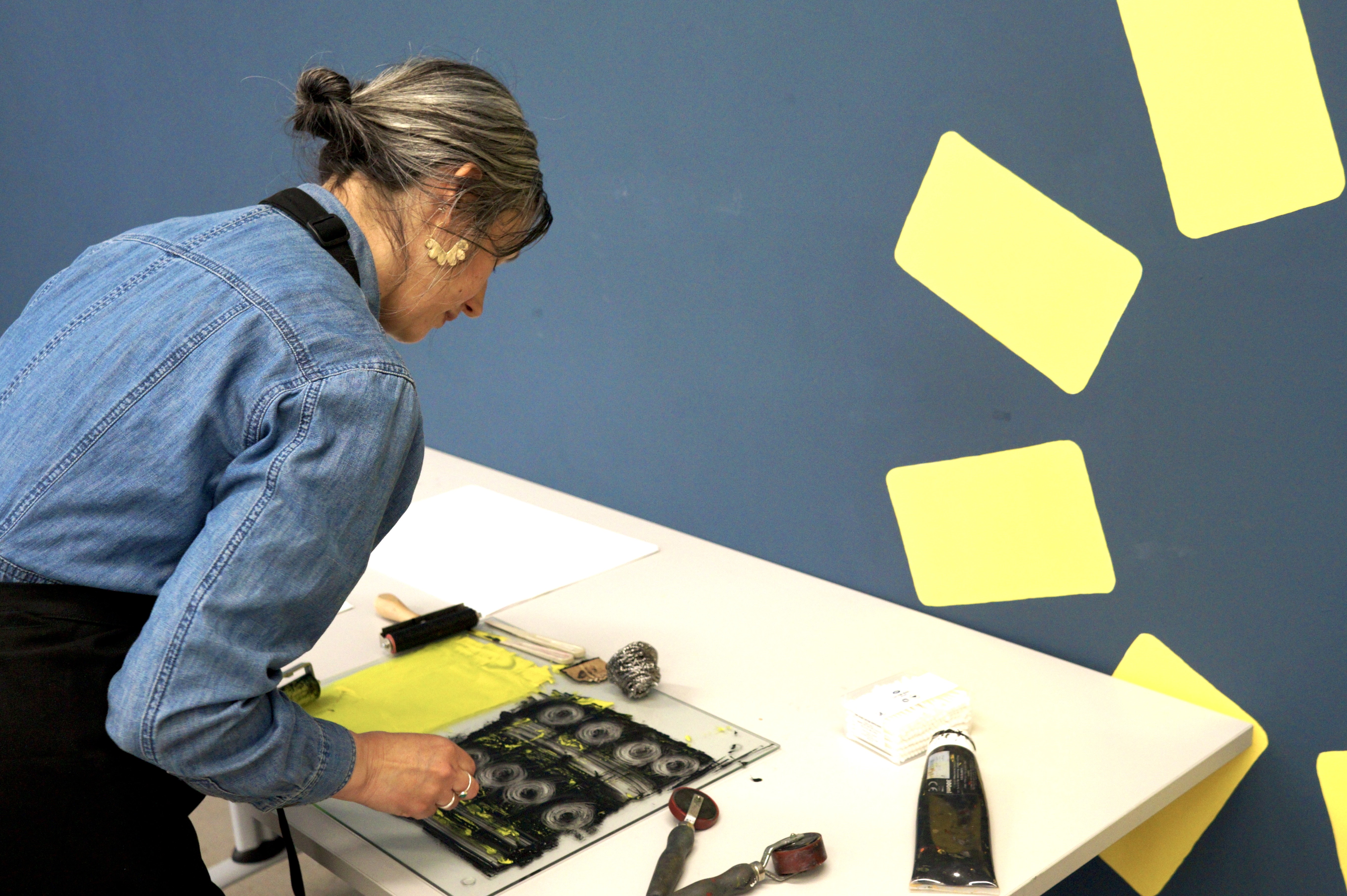 A woman working on a print at the Carousel Print Studio.