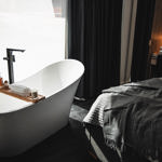 A bedroom with a free standing bath.