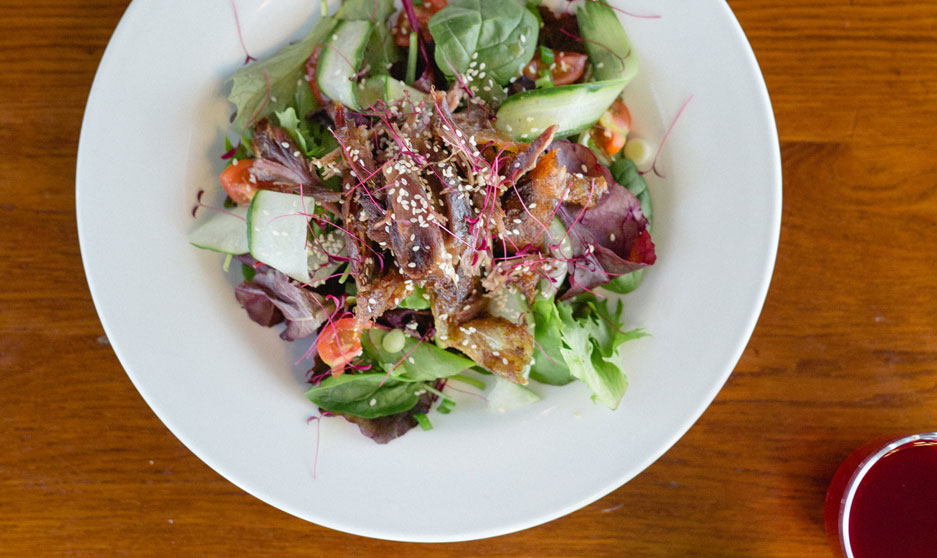 A bowl of salad on a table.