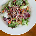 A bowl of salad on a table.