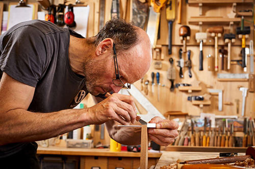 A man working in a carpentry studio.