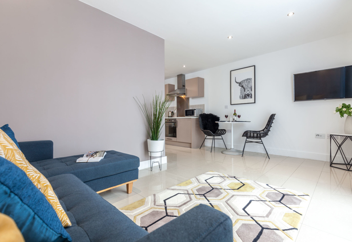 Living room at K Space @ The Point with sofa and modern décor.