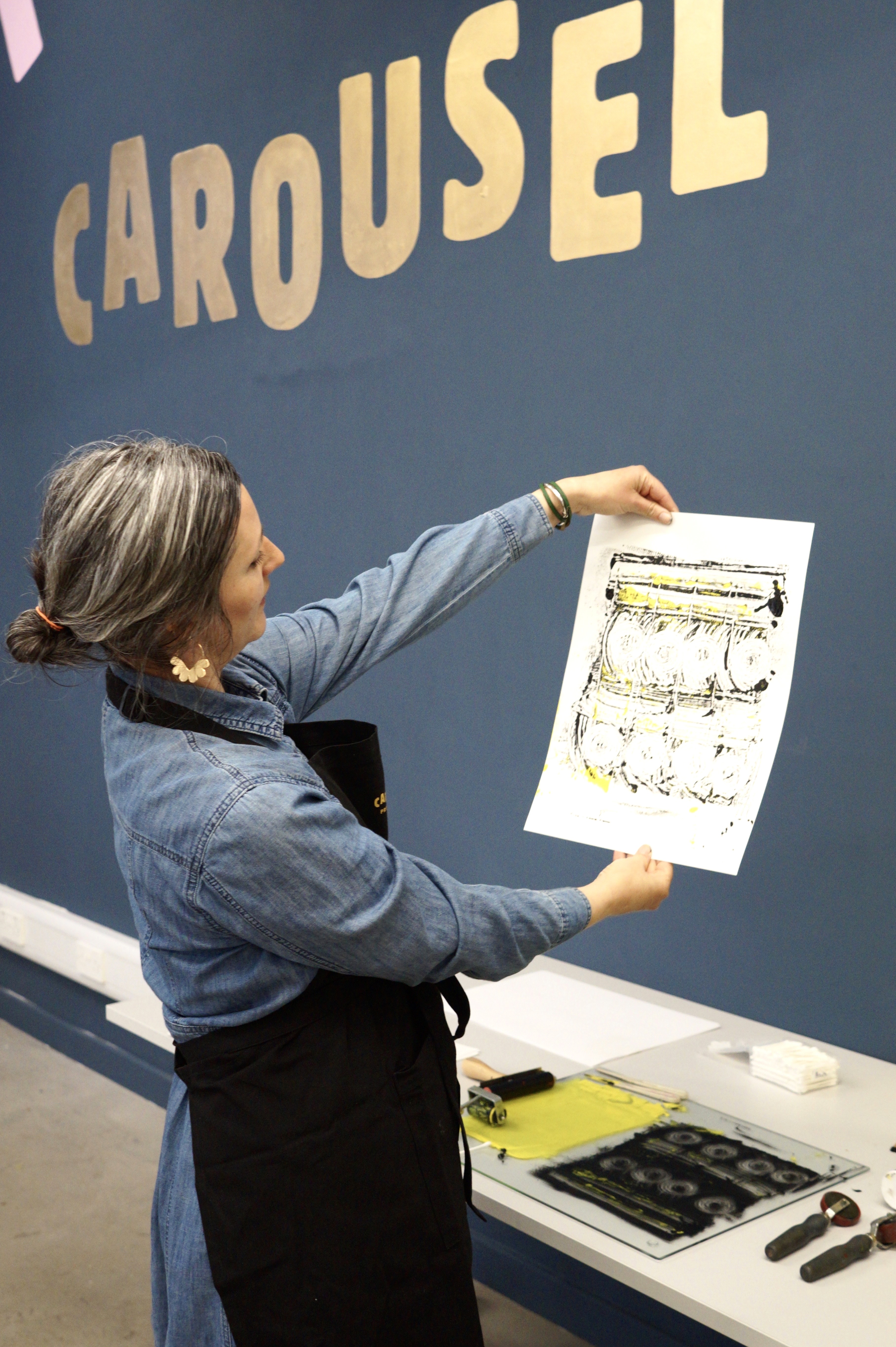 A woman printing at the Carousel Print Studio.