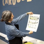 A woman printing at the Carousel Print Studio.