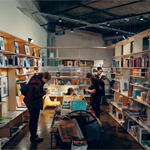 People browsing books and magazines at La Biblioteka in Sheffield.