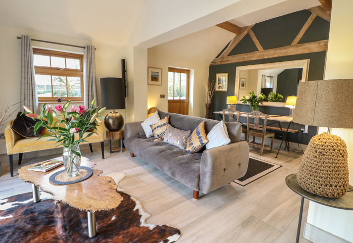 Comfortable living room in a Sykes Holiday Cottage with sofa and coffee table.