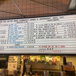 A huge board with beers listed alongside their prices.