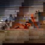 A woman soaking up the the heat of a sauna in Spa 1877