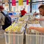 People browsing through crates of records at a Record Fair.