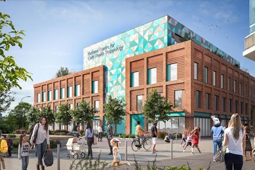 Modern building with a mix of red brick and a patterned upper section featuring teal and white geometric triangles. The sign on the top reads “National Centre for Child Health Technology.” In front of the building, a lively pedestrian area includes people walking, cycling, and pushing strollers. Trees and landscaped planters line the walkway under a bright blue sky with scattered clouds.
