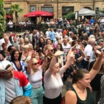 A crowd of people enjoying live music at Leopold Square.