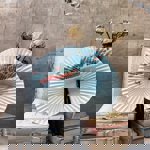 A paper fan arranged with two piles of old books on a table.