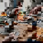 People dining at a rustic wooden table.