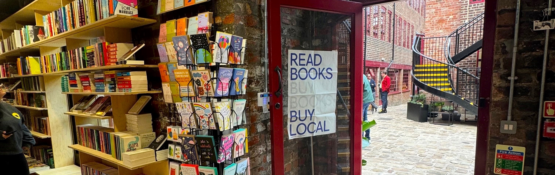 The door to La Biblioteka book shop opening out into Leah'd Yard