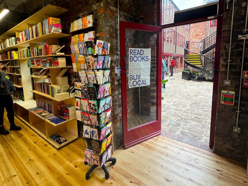 The door to La Biblioteka book shop opening out into Leah'd Yard