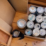 Tins of paint on a wooden floor at the Pete Mckee Gallery.