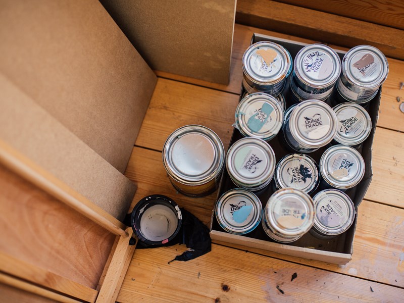 Tins of paint on a wooden floor at the Pete Mckee Gallery.
