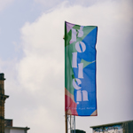 Pollen Market branded flag in front of clock tower.