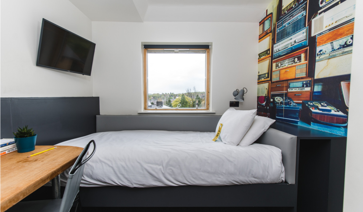 Jonas Court – bedroom with bed, bedside tables, and simple furnishings.