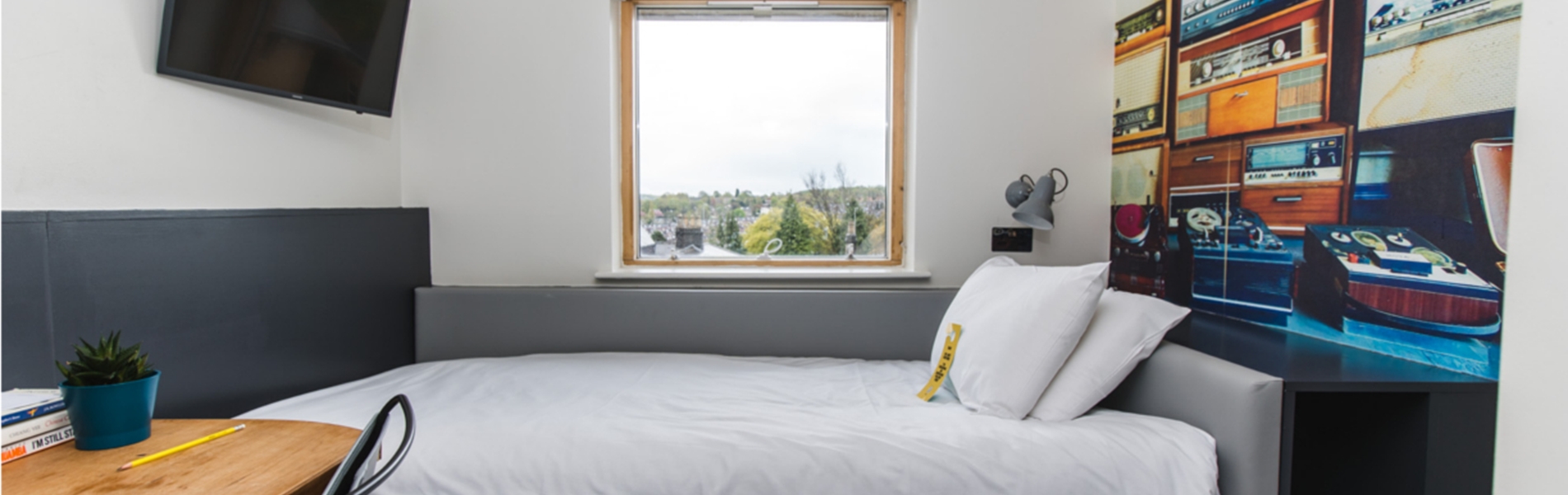 Jonas Court – bedroom with bed, bedside tables, and simple furnishings.