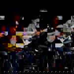 Two people, on stage, playing folk music.