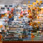 A glass display case sits on a counter, at The Treehouse Cafe, filled with cakes and pastries.