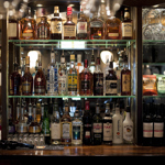 Shelves of spirits and bar snacks behind the bar at The British Oak.