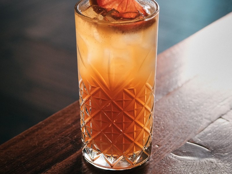 A cocktail in a tall glass.