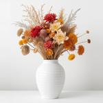 A flower arrangement in a white vase.