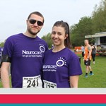 Two runners wearing Neurocare shirts.