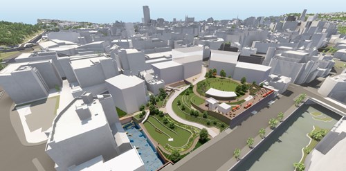 CGI-rendering of an Aerial view of a city center redevelopment plan featuring landscaped green spaces, curved pathways, seating areas, and water features surrounded by white building models representing the urban environment.