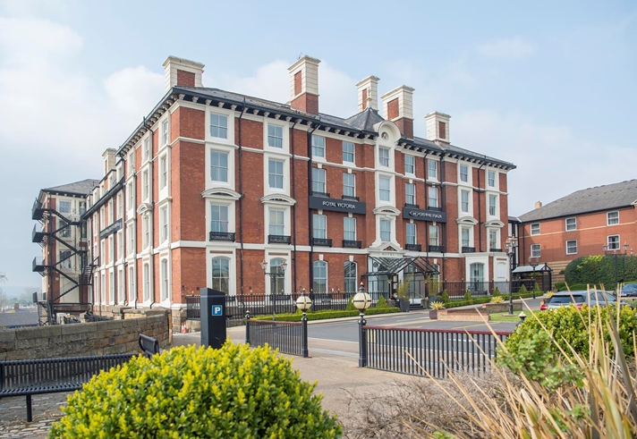 The exterior of the Crowne Plaza Royal Victoria  on a bright sunny day.