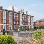 The exterior of the Crowne Plaza Royal Victoria  on a bright sunny day.