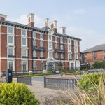 The exterior of the Crowne Plaza Royal Victoria  on a bright sunny day.