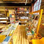 The interior of La Biblioteka bookshop, with all the walls lined with wooden shelves filled with books for sale.