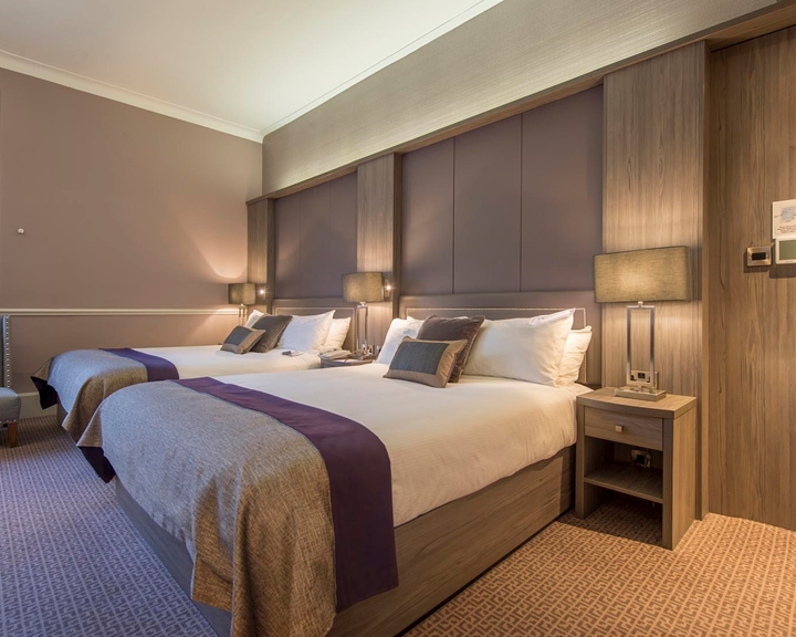 A Deluxe Hotel Room With Twin Beds.