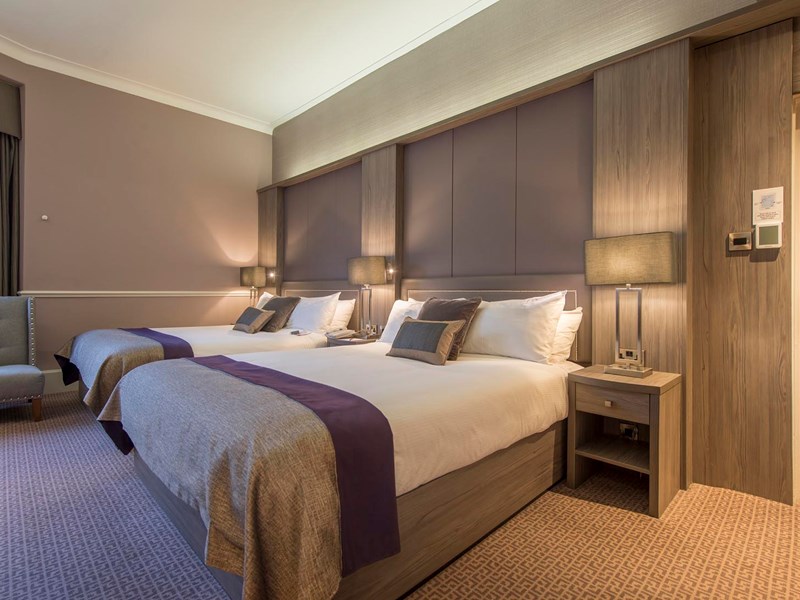 A Deluxe Hotel Room With Twin Beds.