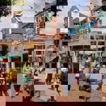 Lots of people are walking about in Orchard Square on a sunny day.