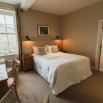Double bedroom at Losehill Hall Hotel with stylish furnishings and a welcoming atmosphere.