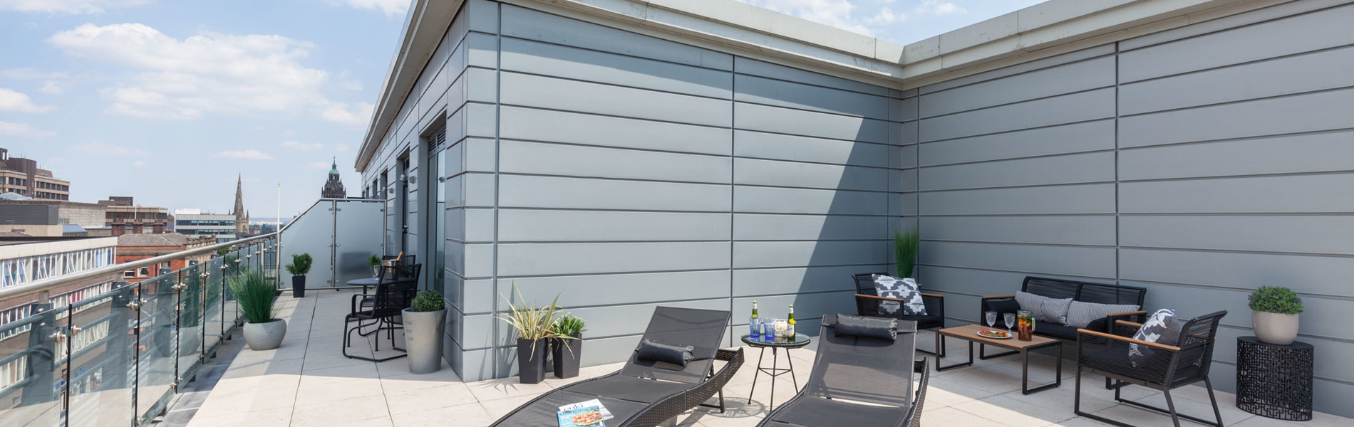 Rooftop patio at K Space @ The Point with outdoor seating and city views.