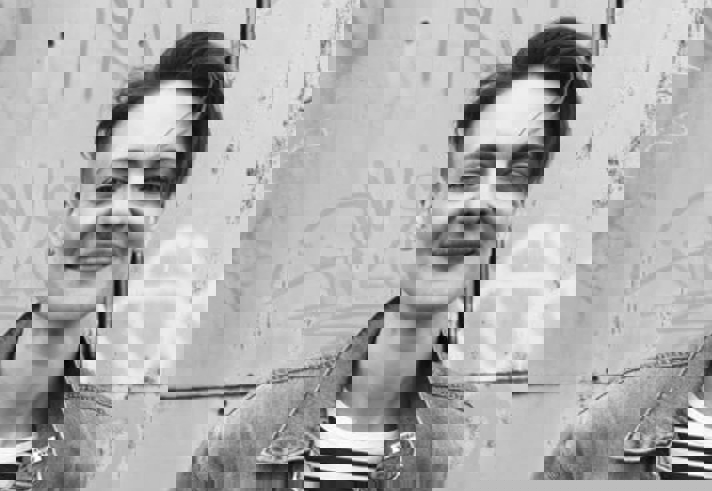 A black and white photo of Finn, who is smiling.