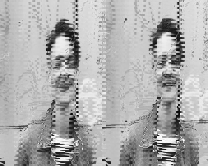 A black and white photo of Finn, who is smiling.