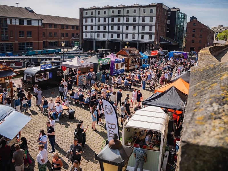 Looking down on the crowds attending Quayside Market in Sheffield on a sunny day