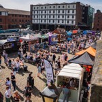 Looking down on the crowds attending Quayside Market in Sheffield on a sunny day 